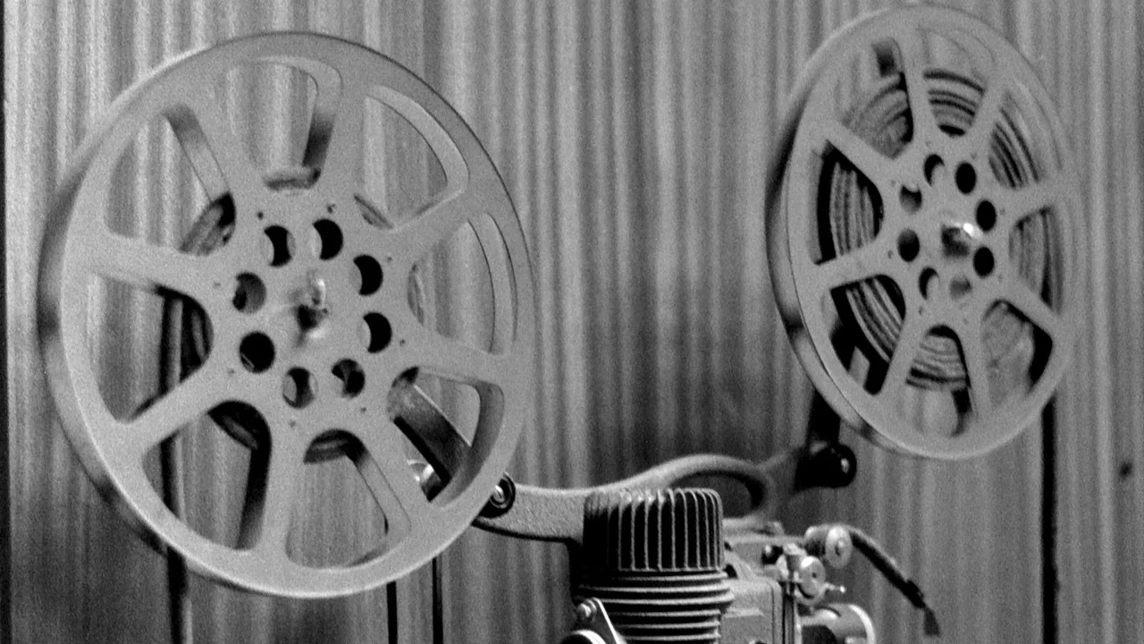 a black and white photo of a movie projector