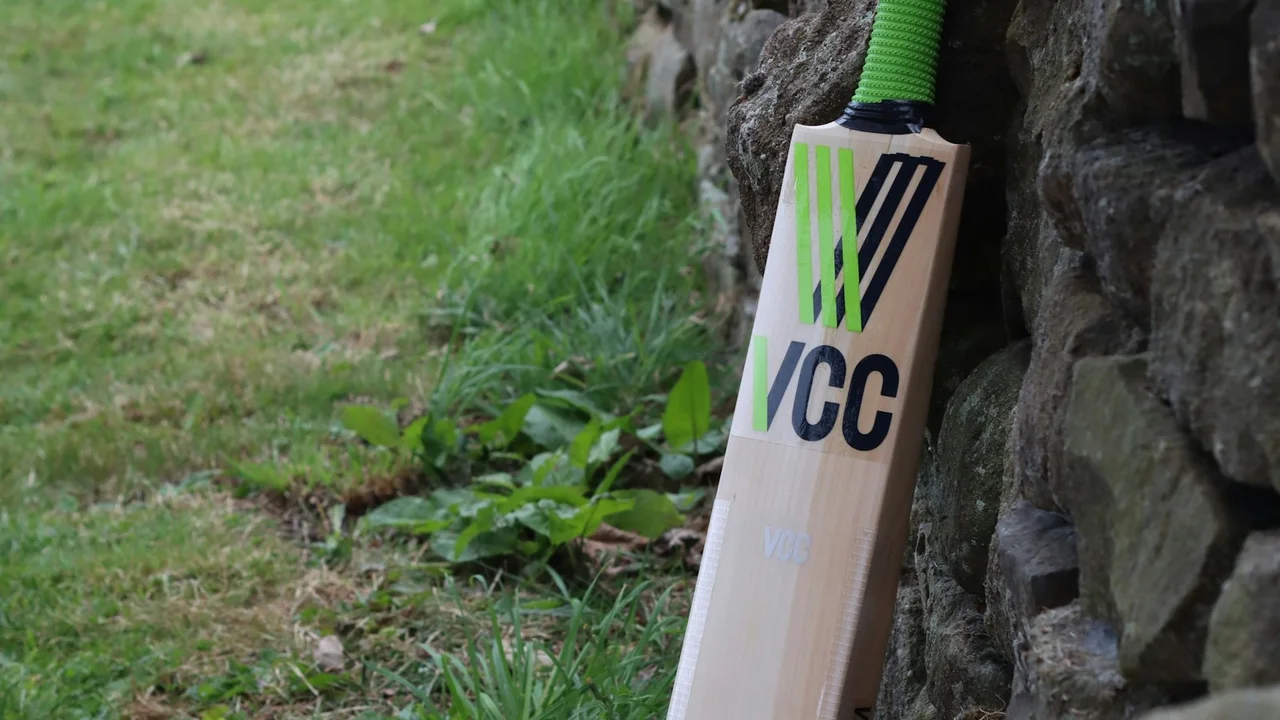 Cricket bat leaning against a stone wall